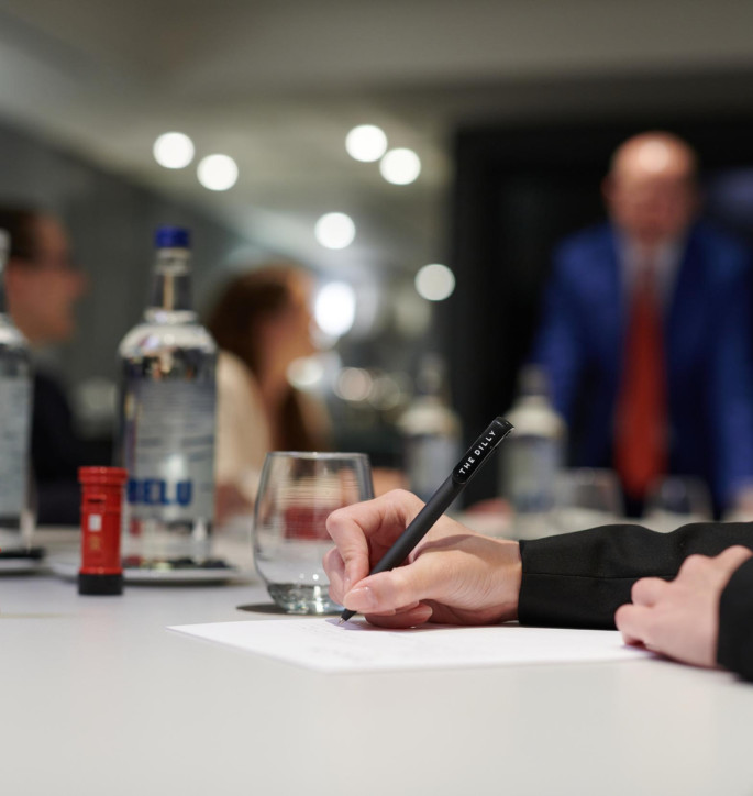 The Dilly London Meeting Room with person writing 