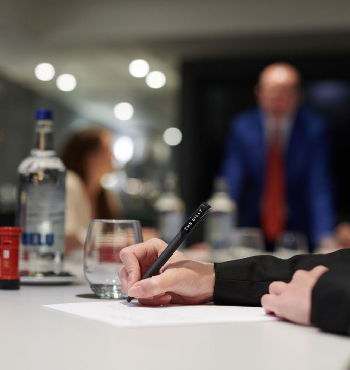 The Dilly London Meeting Room with person writing 