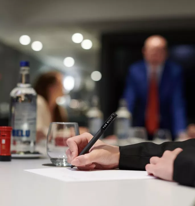 The Dilly London Meeting Room with person writing 